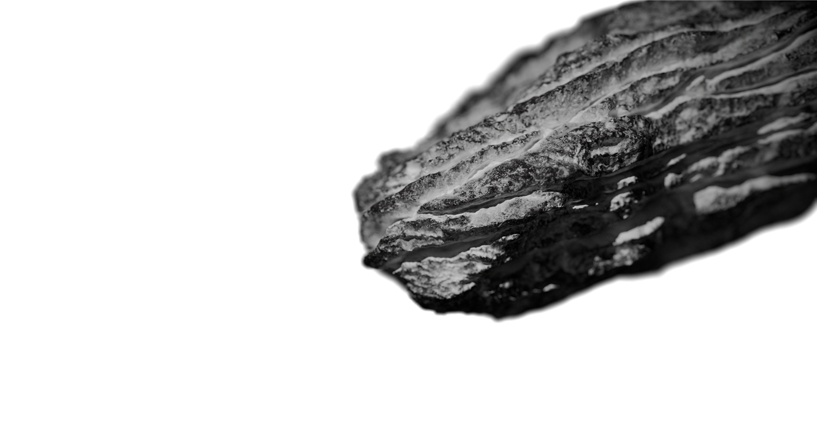 Raw sculpted rock form on a plain background